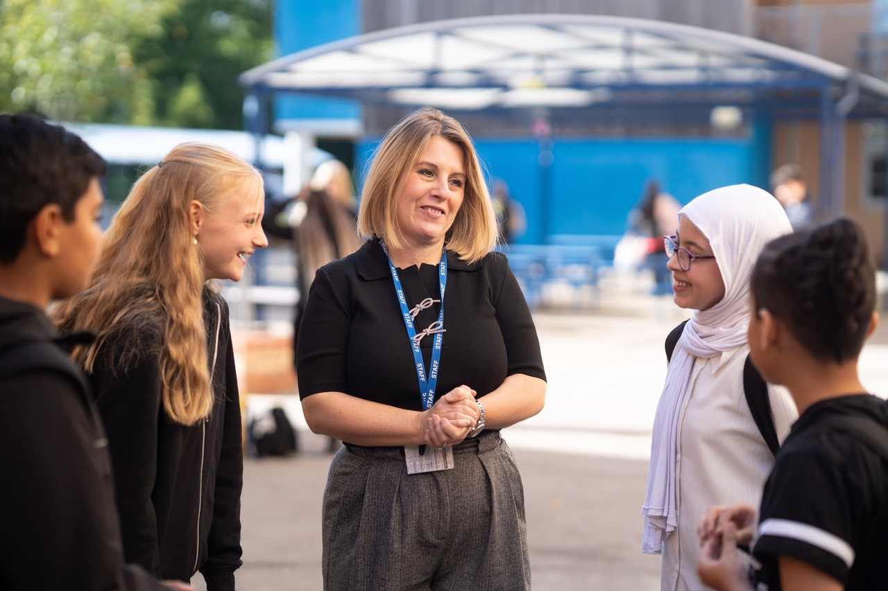 Teacher talking to lower school students